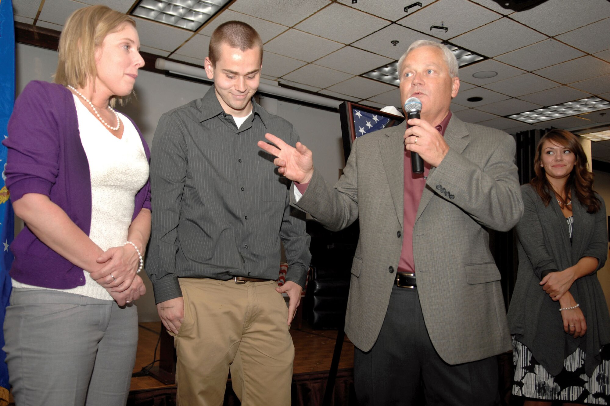 Now retired Brig. Gen. James Melin speaks to the guests at his retirement ceremony held April 10 at the Hap Arnold Club. Surrounding him are his three children, (from left) Sarah, Garett and Chelsea. (U.S. Air Force photo by Staff Sgt. Samara Scott)
