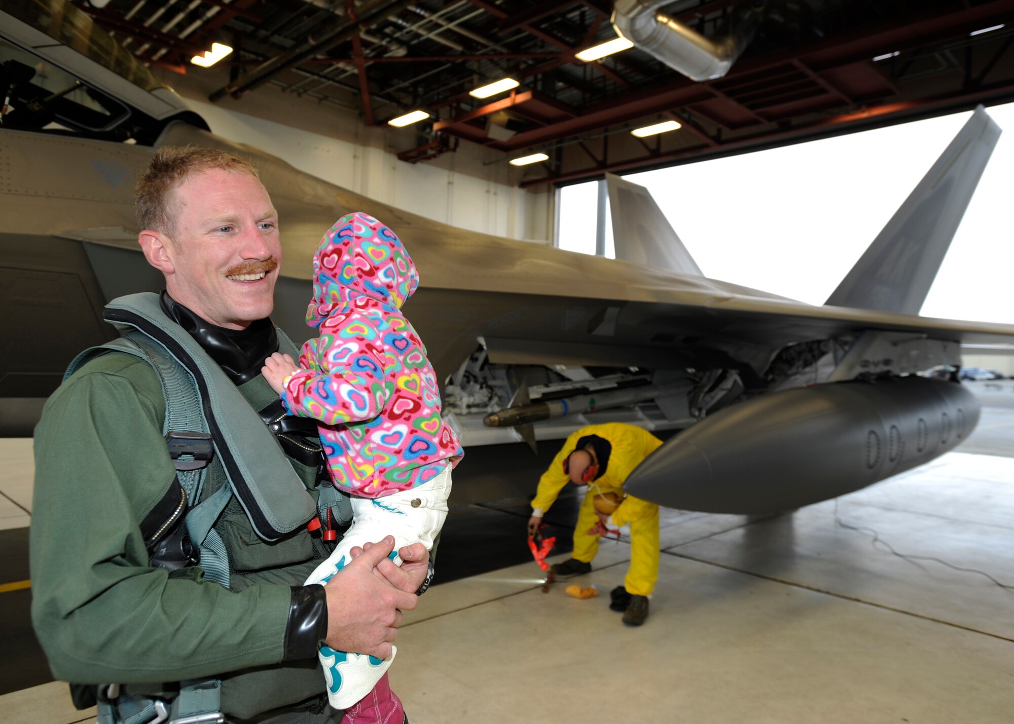 ELMENDORF AIR FORCE BASE, Alaska -- Capt.  Patrick Pearson, 90th Fighter Squadron, greets his daughter Anabelle after returning from Andersen AFB, Guam April 20. Captain Pearson and 15 other F-22 Raptor pilots from the 90th FS were deployed to Guam for four months supporting U.S. Pacific Commands theater security package in the western Pacific. This is the squadron’s third deployment since being activated nearly three years ago. (Air Force photo by Senior Airman Matt Coleman-Foster)