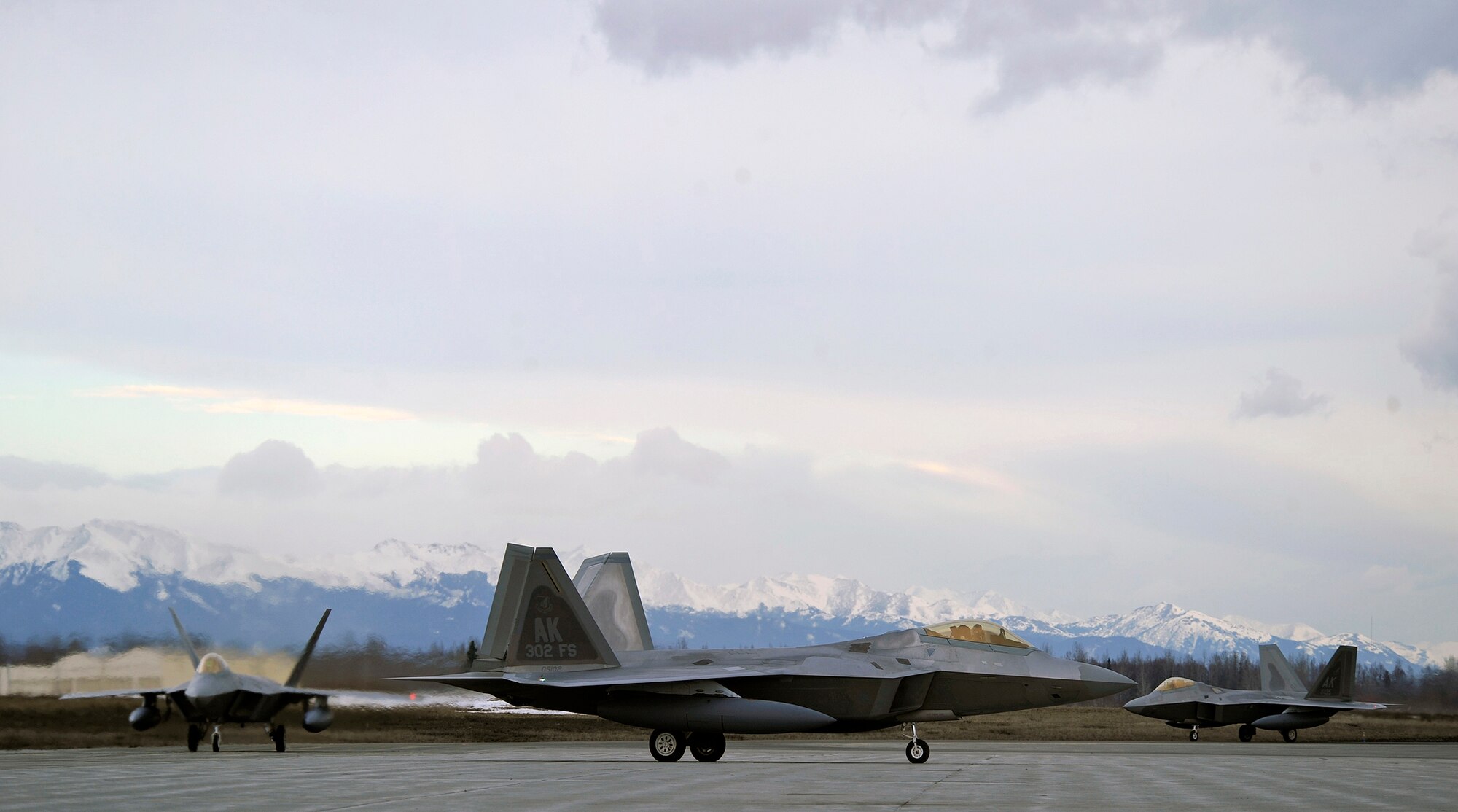 ELMENDORF AIR FORCE BASE, Alaska -- F-22 Raptors assigned to the 90th Fighter Squadron here taxi to their maintenance bays after returning from Andersen AFB,  Guam April 20. Fifteen F-22s were deployed to Guam for four months supporting U.S. Pacific Commands theater security package in the western Pacific. This is the squadron’s third deployment since being activated nearly three years ago. (Air Force photo by Senior Airman Matt Coleman-Foster)


