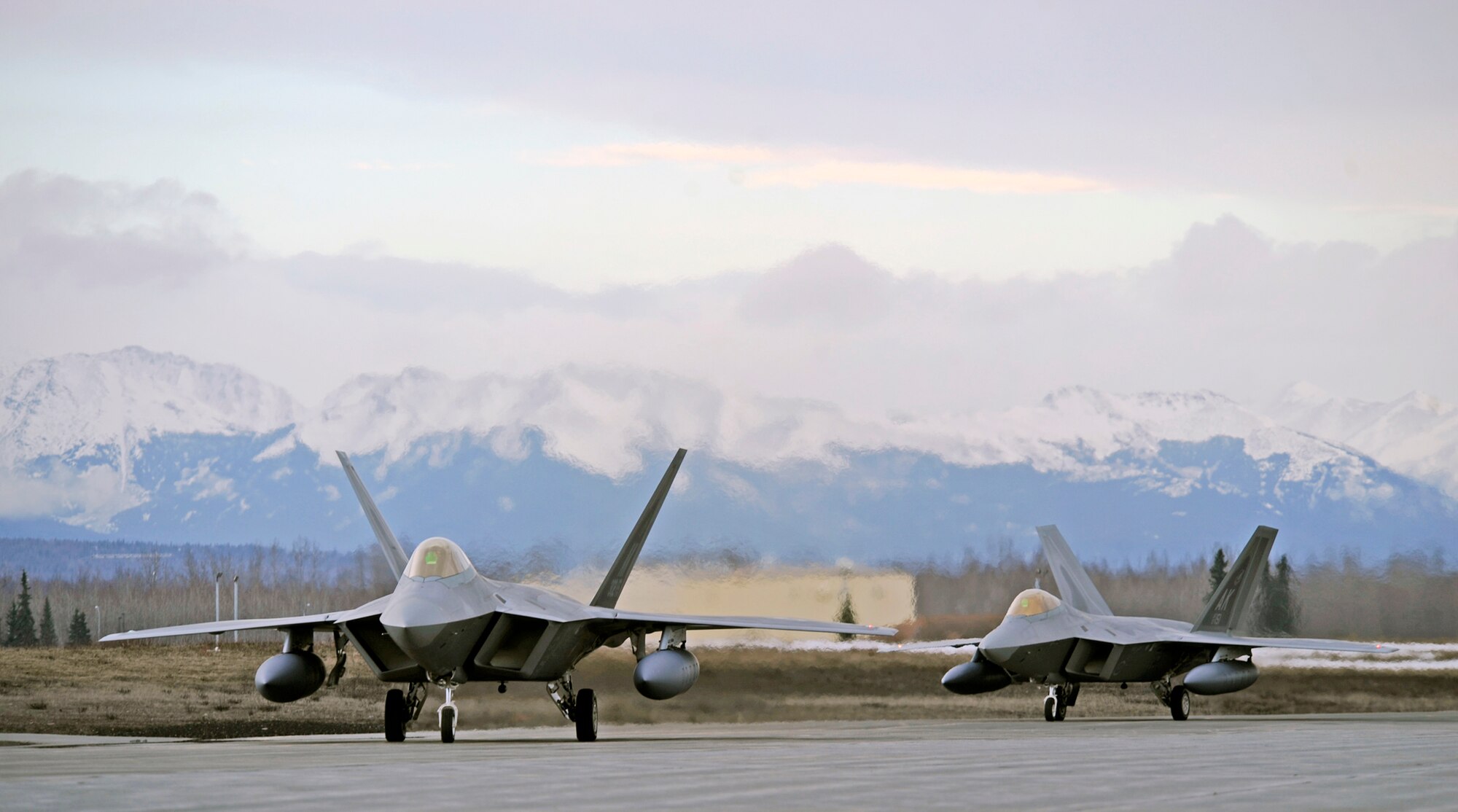 ELMENDORF AIR FORCE BASE, Alaska -- F-22 Raptors assigned to the 90th Fighter Squadron here taxi to their maintenance bays after returning from Andersen AFB, Guam April 20. Fifteen F-22s were deployed to Guam for four months supporting U.S. Pacific Commands theater security package in the western Pacific. This is the squadron’s third deployment since being activated nearly three years ago. (Air Force photo by Senior Airman Matt Coleman-Foster)