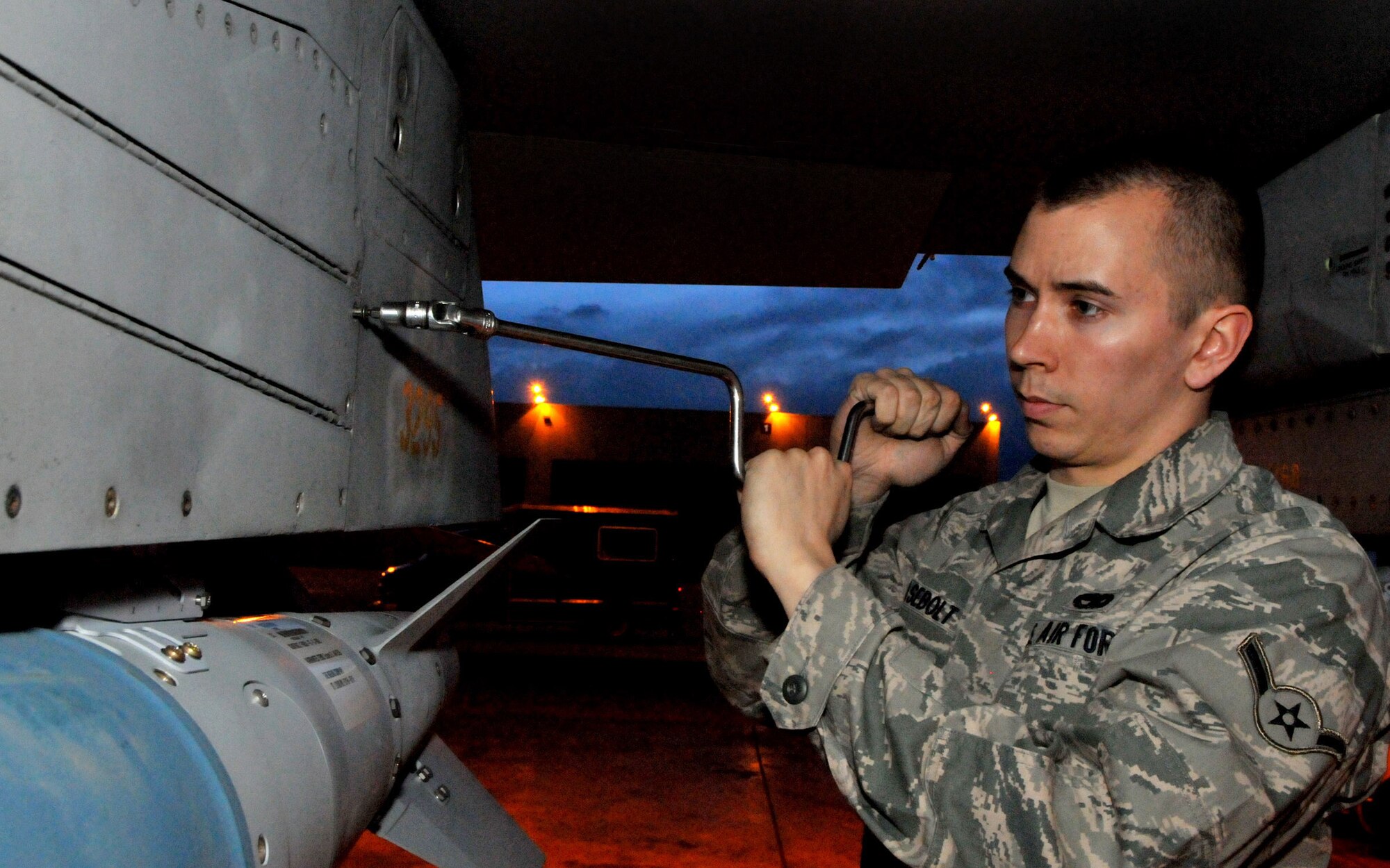 Airman Jon Casebolt tightens a panel after installing an inert Joint Direct Attack Munition GBU-38 to an F-16 Fighting Falcon during Red Flag-Alaska April 19, 2010,  at Eielson Air Force Base, Alaska. Airman Casebolt is a weapons load crewmember with the 8th Aircraft Maintenance Squadron deployed from Kunsan Air Base, South Korea.  (U.S. Air Force photo/Capt. Shannon Collins) 
