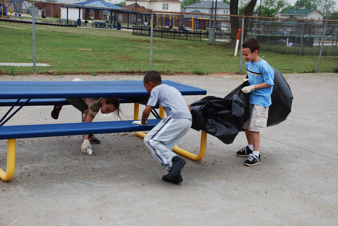 Sheppard Elementary school’s student council participates in a school rubbish patrol to pick up trash left on their school’s playground April 22, 2010.  Kelsey Fitzpatrick (left), fourth-grade student, works with her fellow fourth-graders Marvin Walton (middle) and Austin Dillon (right) to pick up trash at the seating area of their playground.  (U.S. Air Force photo/Tech Sgt. Vernon Cunningham)