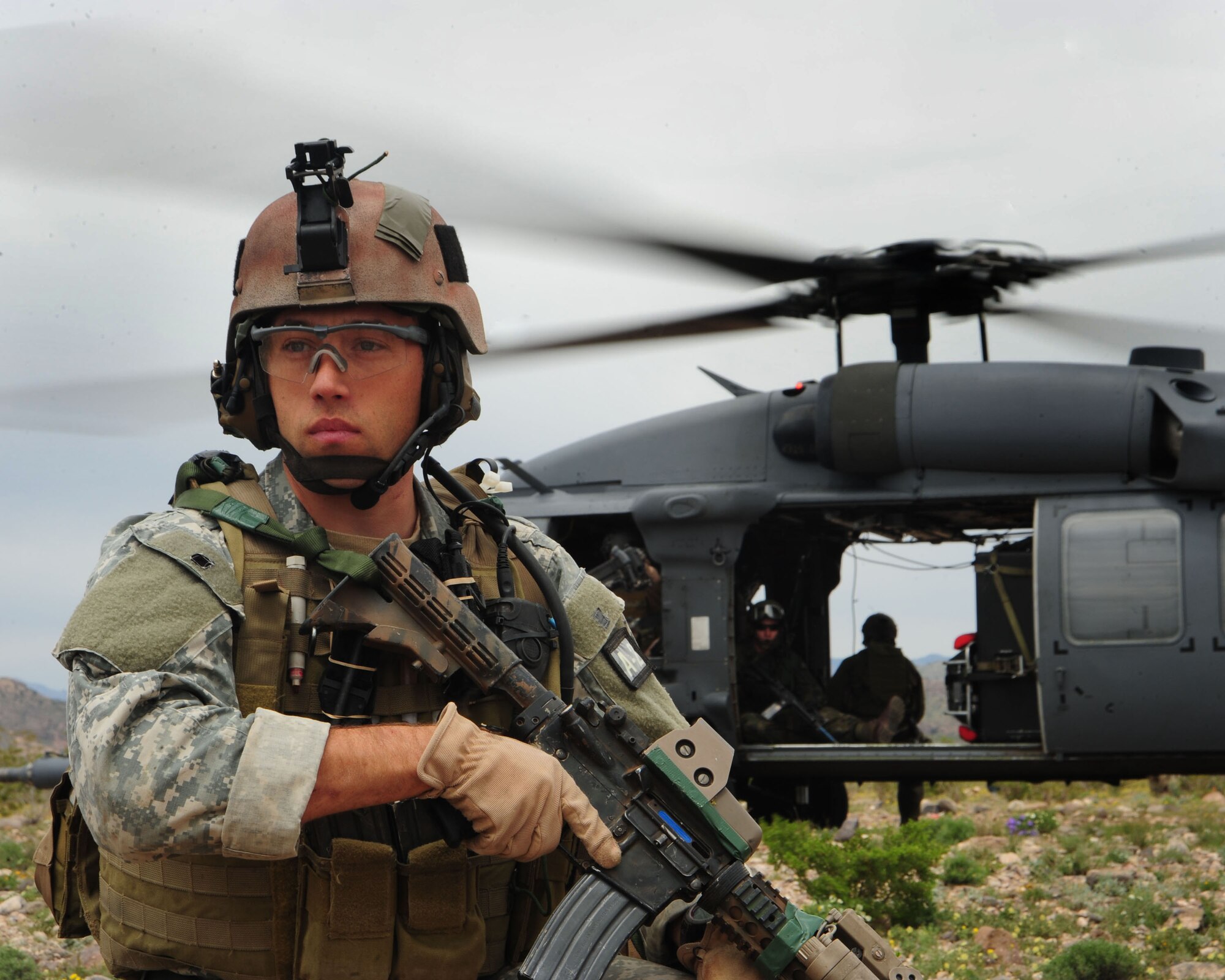 An Army Special Forces medic keeps a watchful eye out for attackers as a UH-1N makes a safe departure from the area during a combat search and rescue exercise as part of Angel Thunder 2010 in Southern Arizona April 19. (U.S. Air Force photo/Airman Jerilyn Quintanilla)

