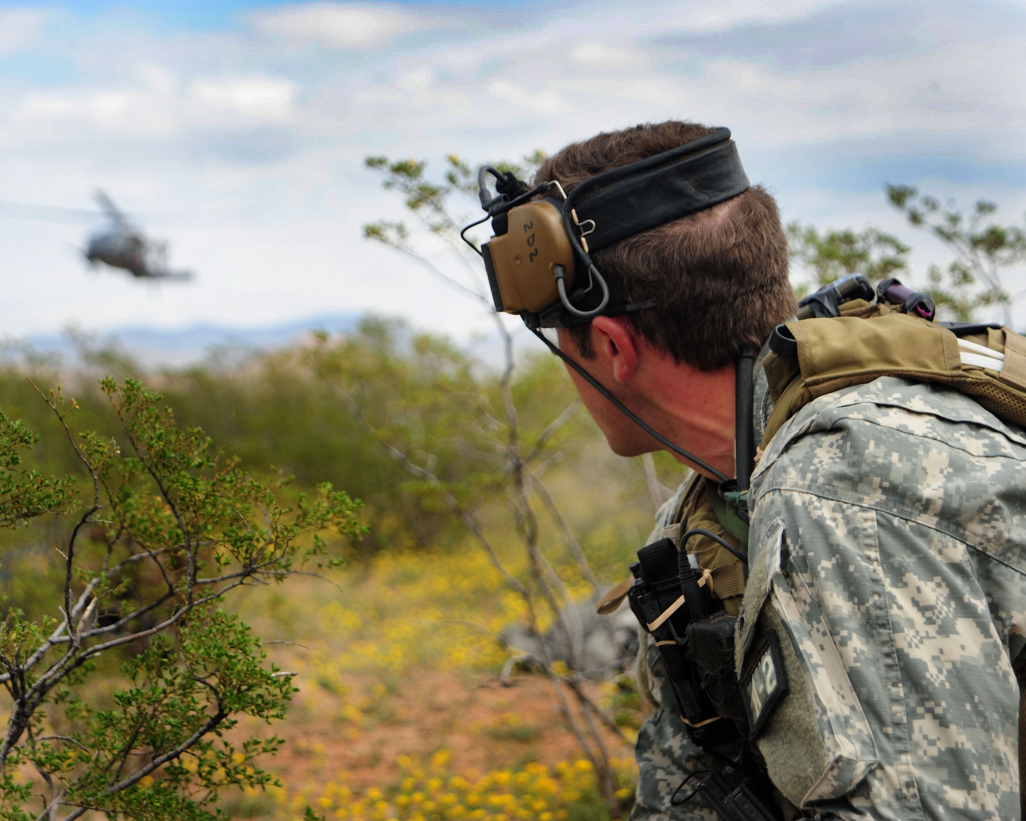 An army Special Forces medic eyes a UH-1N preparing to land during a combat search and rescue exercise as part of Angel Thunder 2010 in Southern Arizona April 19. (U.S. Air Force photo/Airman Jerilyn Quintanilla)