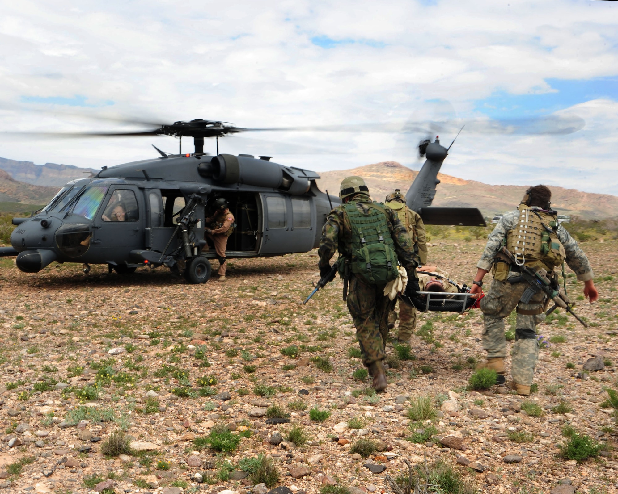 Pararescuemen and an Army Special Forces personnel carry a mock earthquake survivor in need of medical treatment to a UH-1N as part of a combat search and rescue exercise during Angel Thunder 2010 in Southern Arizona April 19. (U.S. Air Force photo/Airman Jerilyn Quintanilla)
