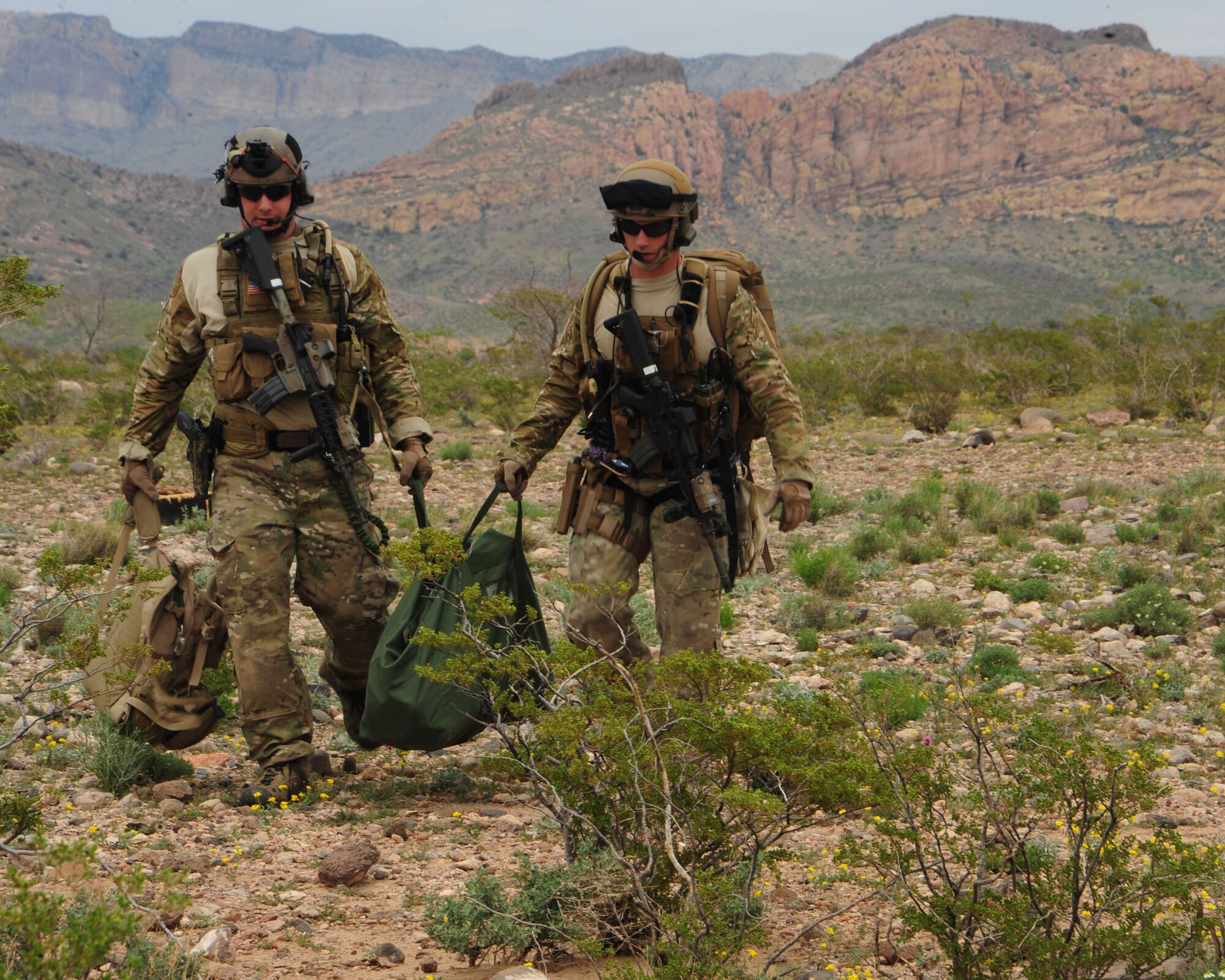 Pararescuemen from the 38th Rescue Squadron carry medical supplies across a stretch of Southern Arizona desert during an earthquake-response exercise April 19. In the scenario, which was part of Angel Thunder 2010, pararescuemen’s first training objective job was to find and treat mock survivors. (U.S. Air Force photo/Airman Jerilyn Quintanilla)

