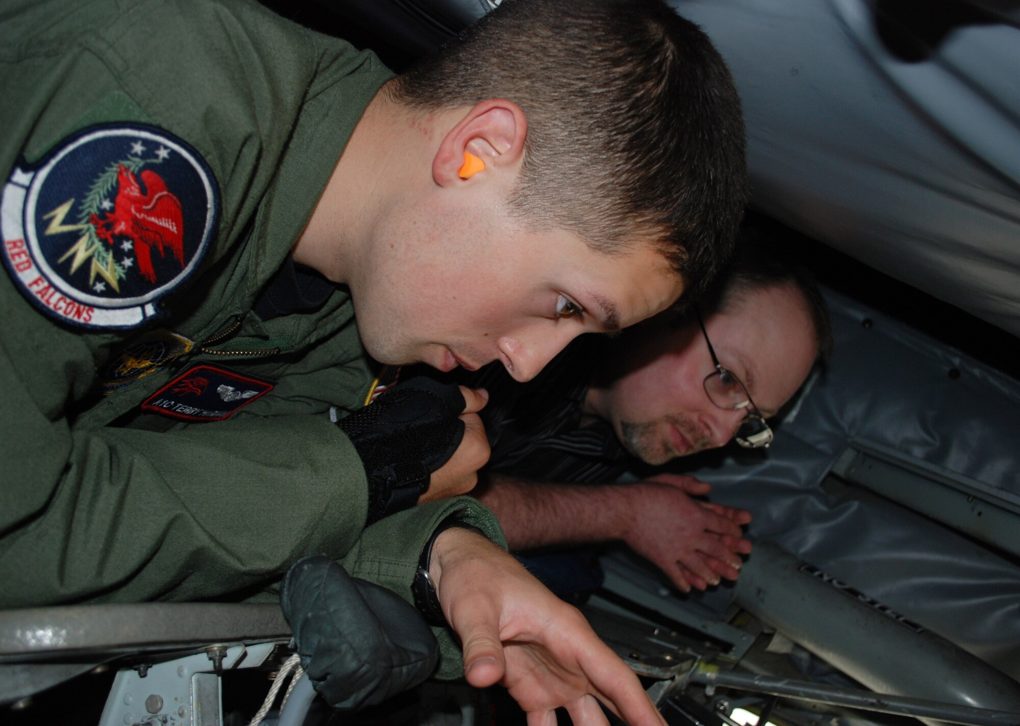 Airman 1st Class Terry Harman, 350th Air Refueling Squadron boom operator, McConnell Air Force Base, Kan., describes of his job to Heath Wineburner, a South Dakota State University aviation student, while in the boom pod of a KC-135 Stratotanker, April 22, 2010.  In addition to the aircraft, Mr. Wineburner and his 11 classmates toured the isochronal inspection dock, air traffic control tower and KC-135 simulator. (U.S. Air Force photo/2nd Lt. Nicholas Mercurio)