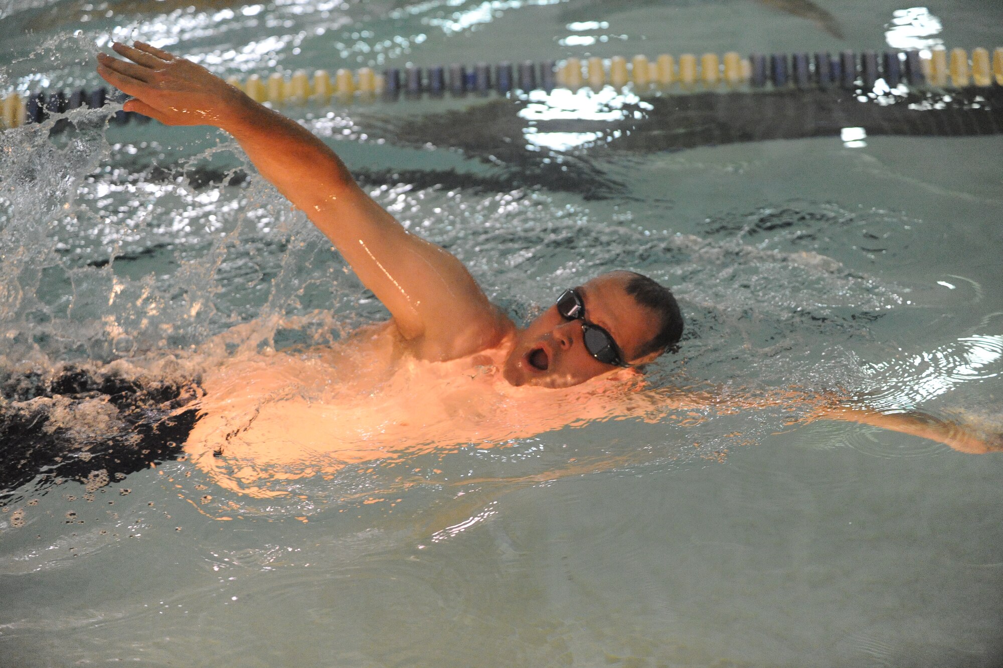 Lt. Col. Scott Thatcher, 350th Air Refueling Squadron commander, swims nine laps during McConnell’s Warrior Day, April 22, 2010, McConnell Air Force Base, Kan. Teams from various units competed against each other demonstrating their physical superiority in an indoor triathlon. The triathlon consisted of a quarter mile swim, three-mile bike race and 1 1/2 mile run. McConnell’s Fitness Center hosted the Warrior Day to promote physical fitness as well as display the facilities they have to offer Team McConnell Airmen and families. (U.S. Air Force photo/Tech. Sgt. Chyrece Campbell)