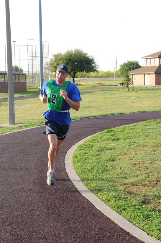 DYESS AIR FORCE BASE, Texas—Staff Sgt. Matthew Johnson, 7th Aircraft Maintenance Squadron, gives a thumbs up while running in the Third Annual Dyess Triathlon here, April 23. The triathlon consisted of a 10-lap swim, a 5-mile stationary bike ride, and a 3-mile run. Sergeant Johnson finished 1st in the 30-and-over group with a final time of 47 minutes and 9 seconds. (U.S Air Force photo/ Airman 1st Class Shannon Hall)