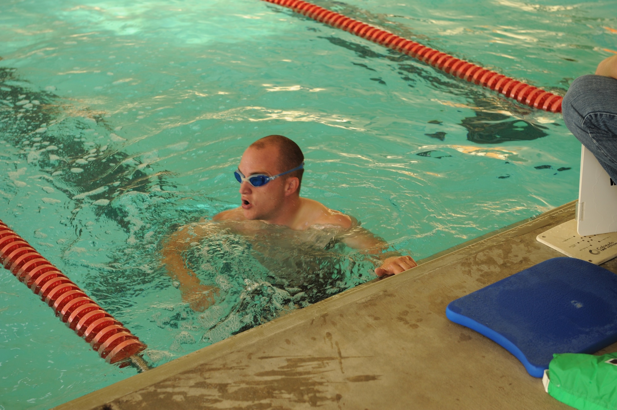 DYESS AIR FORCE BASE, Texas—Airman 1st Class Christopher Teceno, 7th Munitions Squadron, catches his breath in the Dyess Fitness Center pool, April 23 while participating in the Third Annual Dyess Triathlon here.  The triathlon consisted of a 10-lap swim, a 5-mile stationary bike ride, and a 3-mile run. Airman Teceno came in 3rd place in the under-30 group with a final time of 50 minutes and 17 seconds. (U.S Air Force photo/Airman 1st Class Shannon Hall)