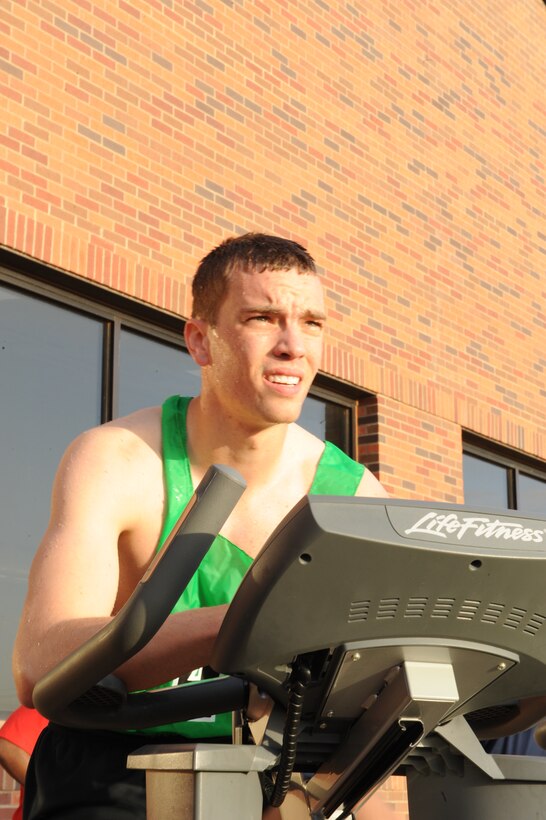 DYESS AIR FORCE BASE, Texas—Staff Sgt. Jason Gooch, 7th Munitions Squadron, rides a stationary bike at the Dyess Fitness Center here, April 23 as part of the Third Annual Dyess Triathlon. The triathlon consisted of a 10-lap swim, 5-mile stationary bike ride and a 3-mile run. Sergeant Gooch finished in 1st place in the under-30 group with a final time of 43 minutes and 19 seconds. (U.S Air Force photo/ Airman 1st Class Shannon Hall) 