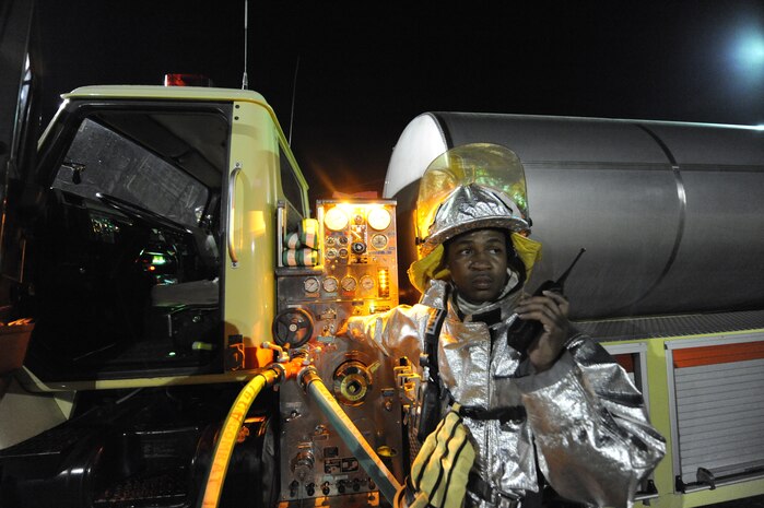 Fredrick Wade conducts water resupply operations during a joint-service, live-fire training evaluation at Joint Base Charleston, S.C., April 21, 2010. The fire training was conducted with Air Force and Navy firefighters from Joint Base Charleston at the crash-fire rescue training facility as part of a 24-hour, live-fire training session each base firefighter is required to complete annually. Mr. Wade is a fire engineer with the 628th Civil Engineer Squadron, Fire Emergency Services Flight. (U.S. Air Force photo/James M. Bowman/released)