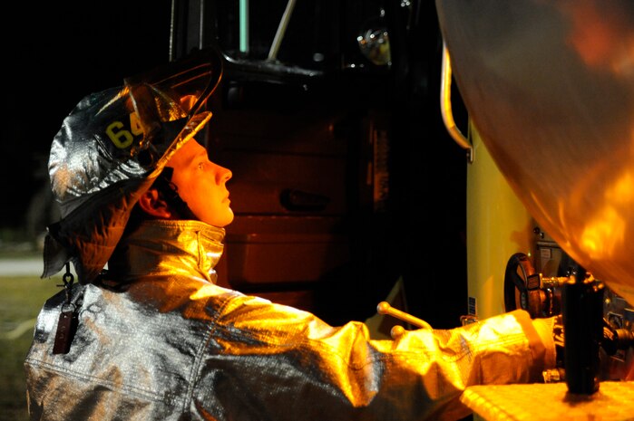 U.S. Air Force Staff Sgt. Justin Sims operates the mid-ship pump panel of a P-26 water tanker vehicle during joint-service firefighting training at Joint Base Charleston, S.C., April 21, 2010. The P-26 water tanker vehicle was used to establish water resupply operations to an aircraft rescue firefighting vehicle. The P-26 holds approximately 6,000 gallons of water. Sergeant Sims is a firefighter with the 628th Civil Engineer Squadron, Fire Emergency Services Flight. (U.S. Air Force photo/James M. Bowman/released)