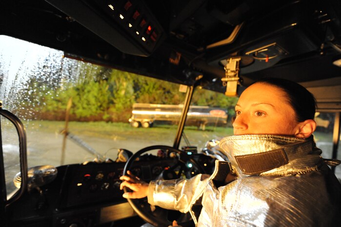 U.S. Air Force Staff Sgt. Stephanie Pyles drives a P-23 fire truck while conducting a fire suppression oscillation operation on a simulated aircraft at Joint Base Charleston, S.C., April 21, 2010. The simulation is part of a 24-hour, live-fire training session each base firefighter is required to complete annually. The P-23 has two tanks; one holds 3,300 gallons of water, and the other tank holds 500 gallons of fire-retardant foam. Sergeant Pyles is a crew chief with the 628th Civil Engineer Squadron, Fire Emergency Services Flight. (U.S. Air Force photo/James M. Bowman/released)