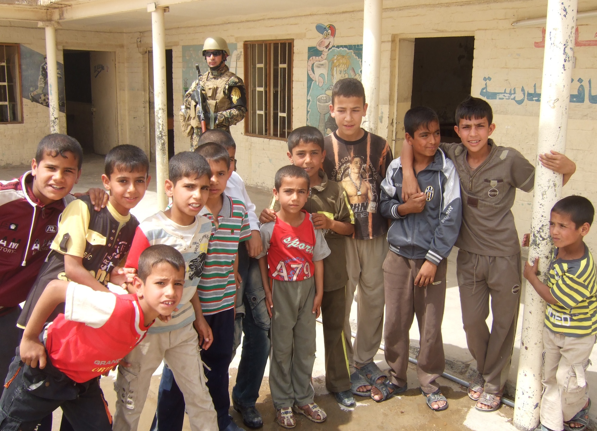Airmen and Soldiers from Kirkuk Regional Air Base, Iraq, hand out school supplies to local children as part of two programs, Operation Soccer Ball and Operation School Supplies, that are carried out by volunteers at the base.  (U.S. Air Force photo/Senior Airman Blake Draper)