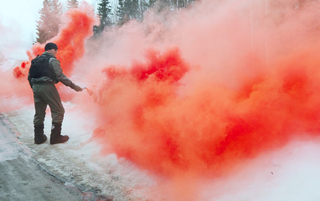 Capt. Josh Peck practices sending a flare signal during survival, evasion, resistance and escape refresher training April 12, 2010, at Elmendorf Air Force Base, Alaska. Captain Peck is a pilot with the 962nd Airborne Air Control Squadron. (U.S. Air Force photo/Senior Airman Cynthia Spalding)