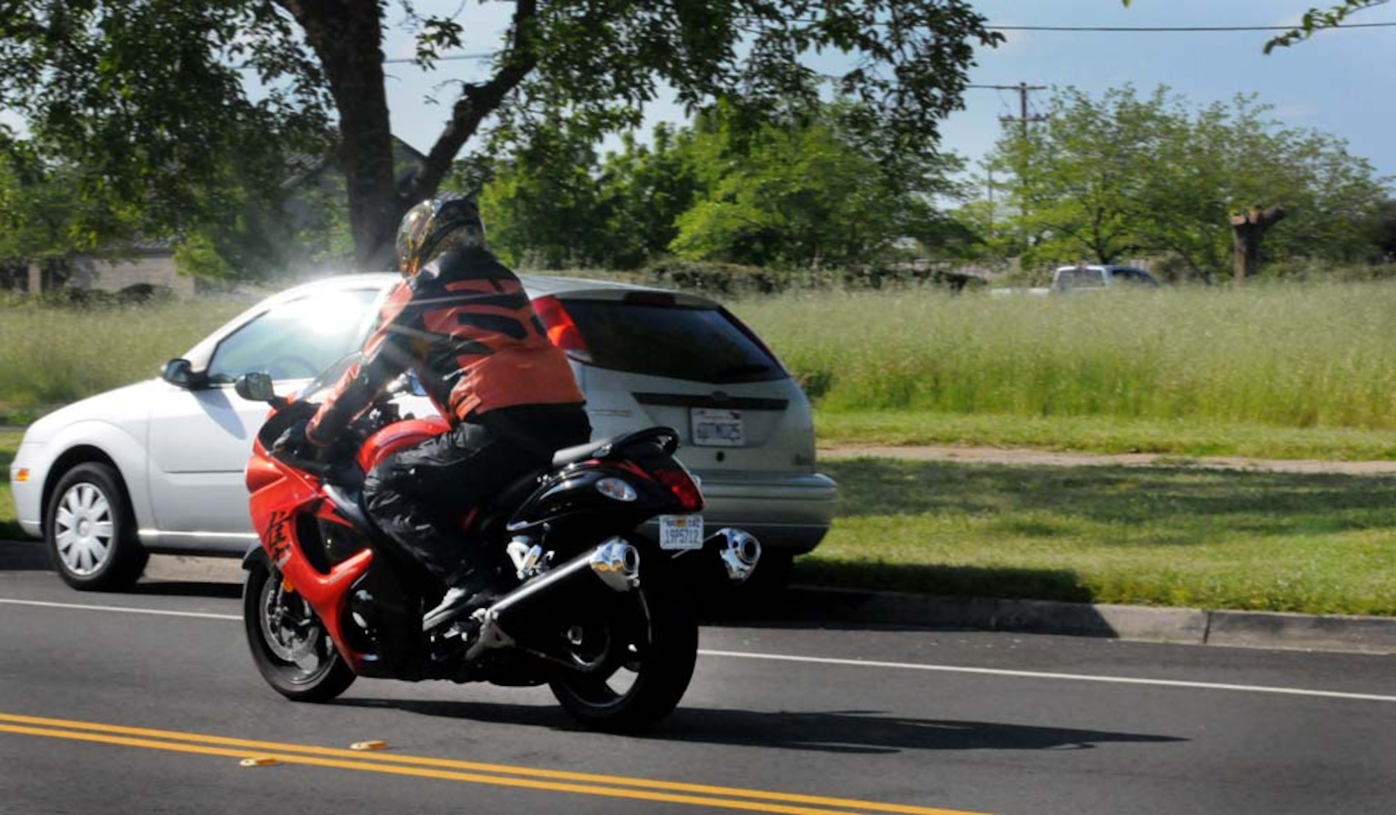 Mr. Frank Lucero, 9th Communications Squadron director of plans and resources, rides his motorcycle April 23, in front of the 9th Communications building. Mr. Lucero always wears his protective equipment when riding his motorcycle. (Air Force photo by Airman 1st Class David Tracy)