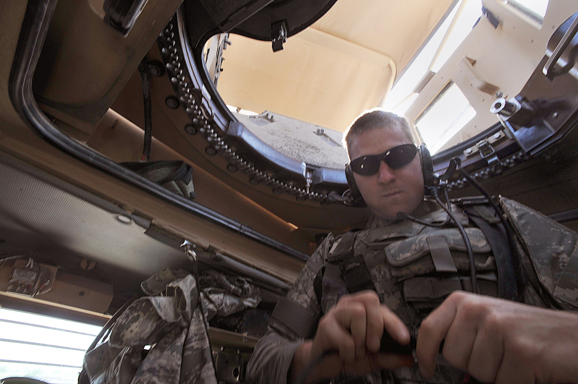 Airman 1st Class Andrew Koss checks the connection to his headset in a mine-resistant, ambush-protected vehicle before a joint patrol with the Soldiers April 14, 2010, at Joint Base Balad, Iraq. Airman Koss is from the 532nd Expeditionary Security Forces Squadron deployed from Eielson Air Force Base, Alaska. (U.S. Air Force photo/Staff Sgt. Quinton Russ) 