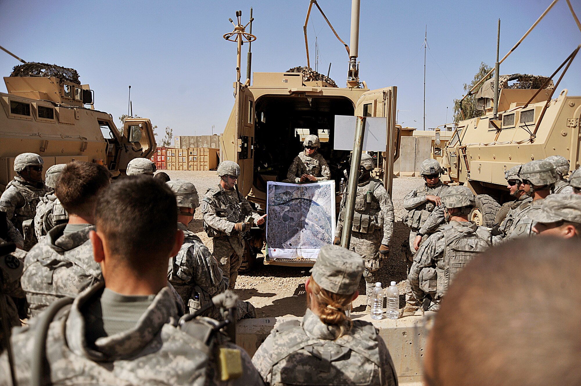 Airmen and Soldiers brief before a patrol April 14, 2010, at Joint Base Balad, Iraq. The patrol is a joint effort between Army and Air Force members looking for a weapons cache. (U.S. Air Force photo/Staff Sgt. Quinton Russ) 
