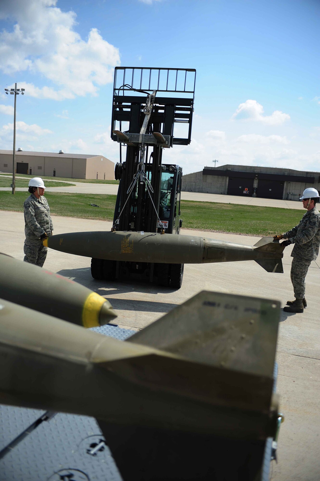 ELLSWORTH AIR FORCE BASE, S.D.- Munitions conventional maintenance crew members move a Mark 84 bomb, April 21. The B-1B Lancer has a payload of 125,000 pounds and has the ability of carrying 24 Mark 84’s along with other munitions.  (U.S. Air Force photo/Airman 1st Class Corey Hook)