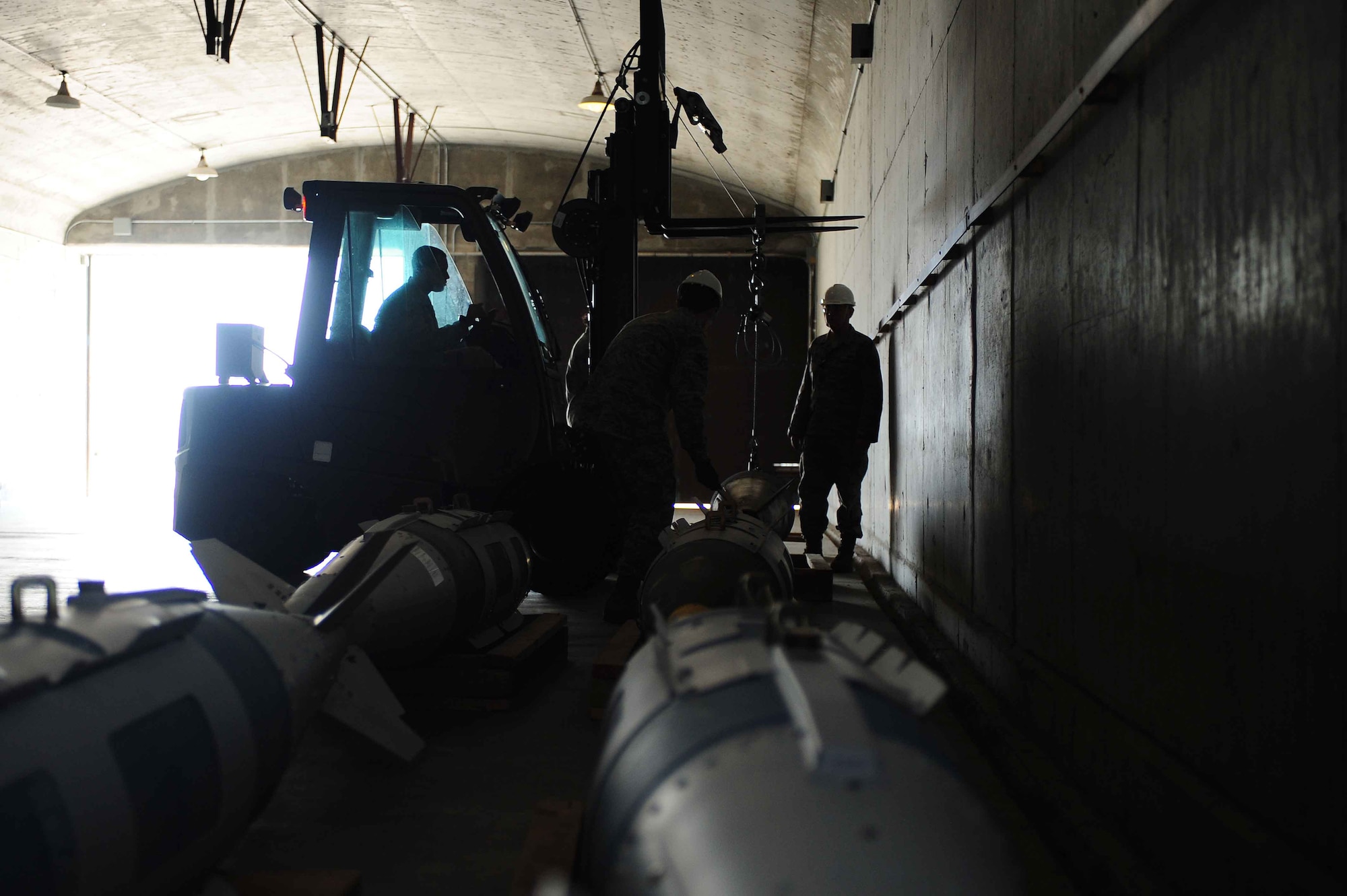 ELLSWORTH AIR FORCE BASE, S.D.- Munitions conventional maintenance crew members store a Mark 84 bomb inside a hardened structure, April 21. The 28th Munitions Squadron is responsible for more than 1,600 munitions line items, 87 facilities, 3.5 million pounds net explosive weight and 640-acres of munitions storage area. (U.S. Air Force photo/Airman 1st Class Corey Hook)