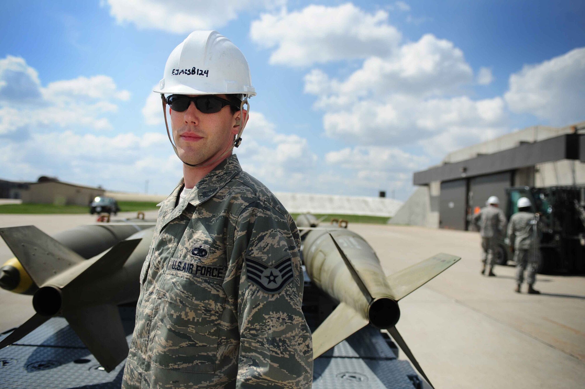 ELLSWORTH AIR FORCE BASE, S.D.- Staff Sgt. Clifford Fuls, 28th Munitions Squadron conventional maintenance crew chief, stands in front of Mark 84 bombs, April 21. Sergeant Fuls works within the production flight where he helps assemble, maintain, and deliver all types of munitions stored at Ellsworth. (U.S. Air Force photo/Airman 1st Class Corey Hook)