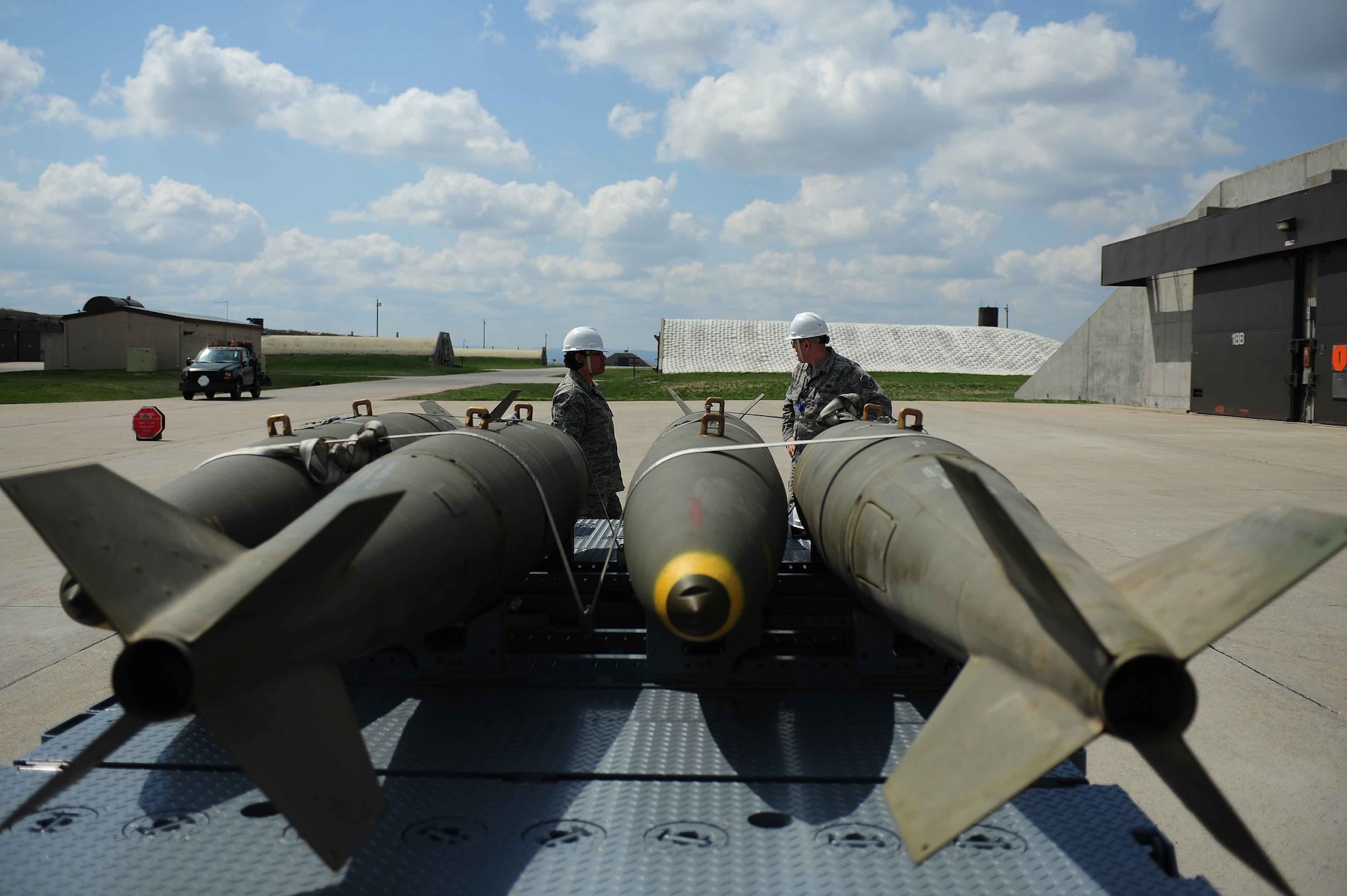 ELLSWORTH AIR FORCE BASE, S.D.- (Left) Senior Airman Jennifer Peterson and Staff Sgt. Jeremiah Phelps prepare to move Mark 84 bombs inside a hardened structure, April 21. Both Airmen are assigned to the 28th Munitions Squadron as conventional maintenance crew chiefs. The process of moving and storing munitions inside hardened structures is known as “warehousing.” (U.S. Air Force photo/Airman 1st Class Corey Hook)
