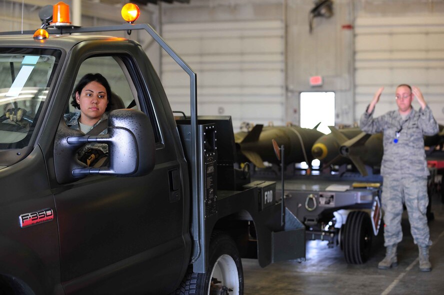 ELLSWORTH AIR FORCE BASE, S.D.- (Front) Senior Airman Jennifer Peterson and Staff Sgt. Jeremiah Phelps prepare to move two trailers of Mark 84 bombs, April 21. The bombs are being moved and warehoused inside a hardened structure. Both Airmen are assigned to the 28th Munitions Squadron as conventional maintenance crew chiefs. (U.S. Air Force photo/Airman 1st Class Corey Hook)