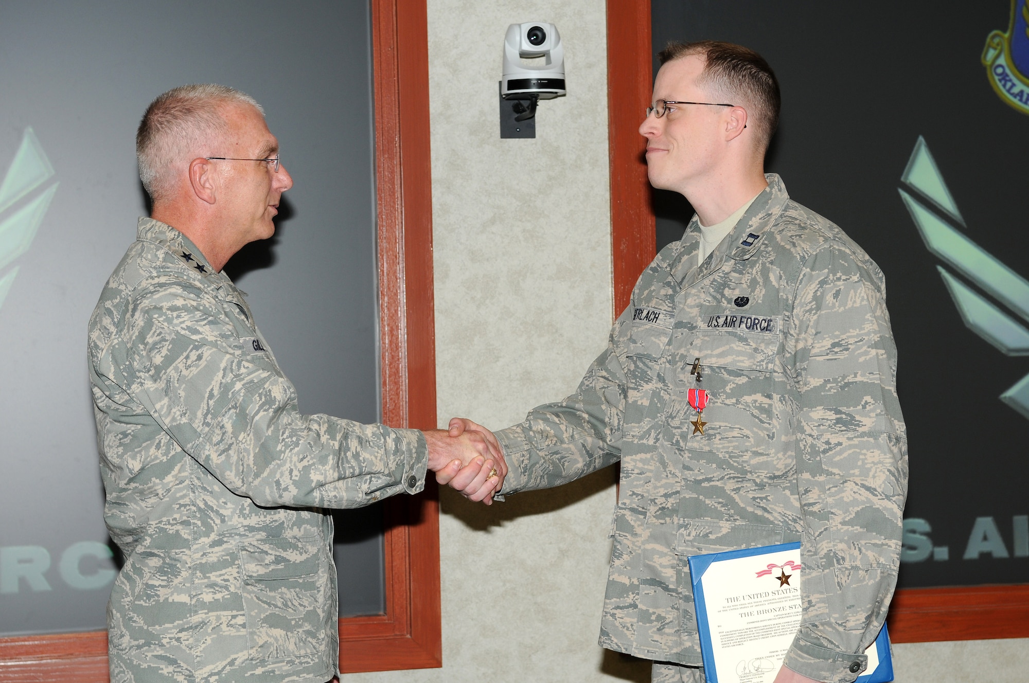 Capt. Kurt Gerlach was presented a Bronze Star by Maj. Gen. David Gillett, Oklahoma City Air Logistics Center commander, recently. Captain Gerlach earned the medal during a deployment on combat operations in Iraq while assigned to the Combined Joint Special Operations Task Force – Arabian Peninsula. The citation reads, in part: “His actions are in keeping with the finest traditions of military service and reflect distinct credit upon himself, Special Operations Command Central and the United States Air Force.” (Air Force photo by Dave Faytinger)