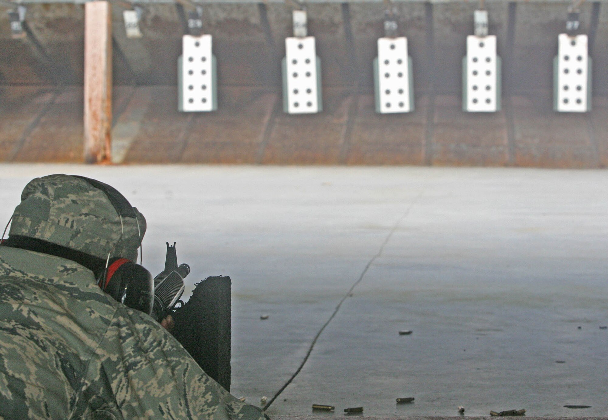 Left, an Airman with the 162nd Combat Communications Group of the California Air National Guard fires an M16 on his target during the marksmanship portion of the Combat Challenge. (Air Force photos by John Stuart)