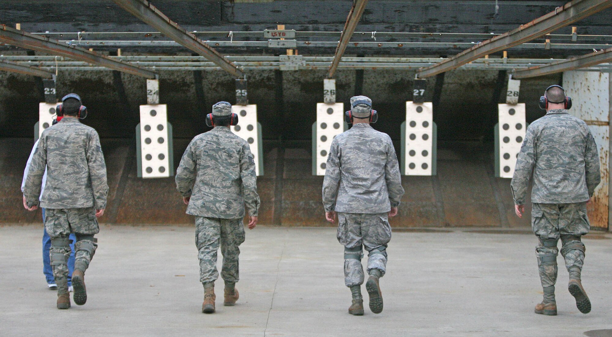 Above, California Air National Guardsmen with the 162nd Combat Communications Group move downrange to check their targets April 19. Marksmanship was an important facet to the competition as enlisted team members fired M16s and officers shot M9s. (Air Force photos by John Stuart)
