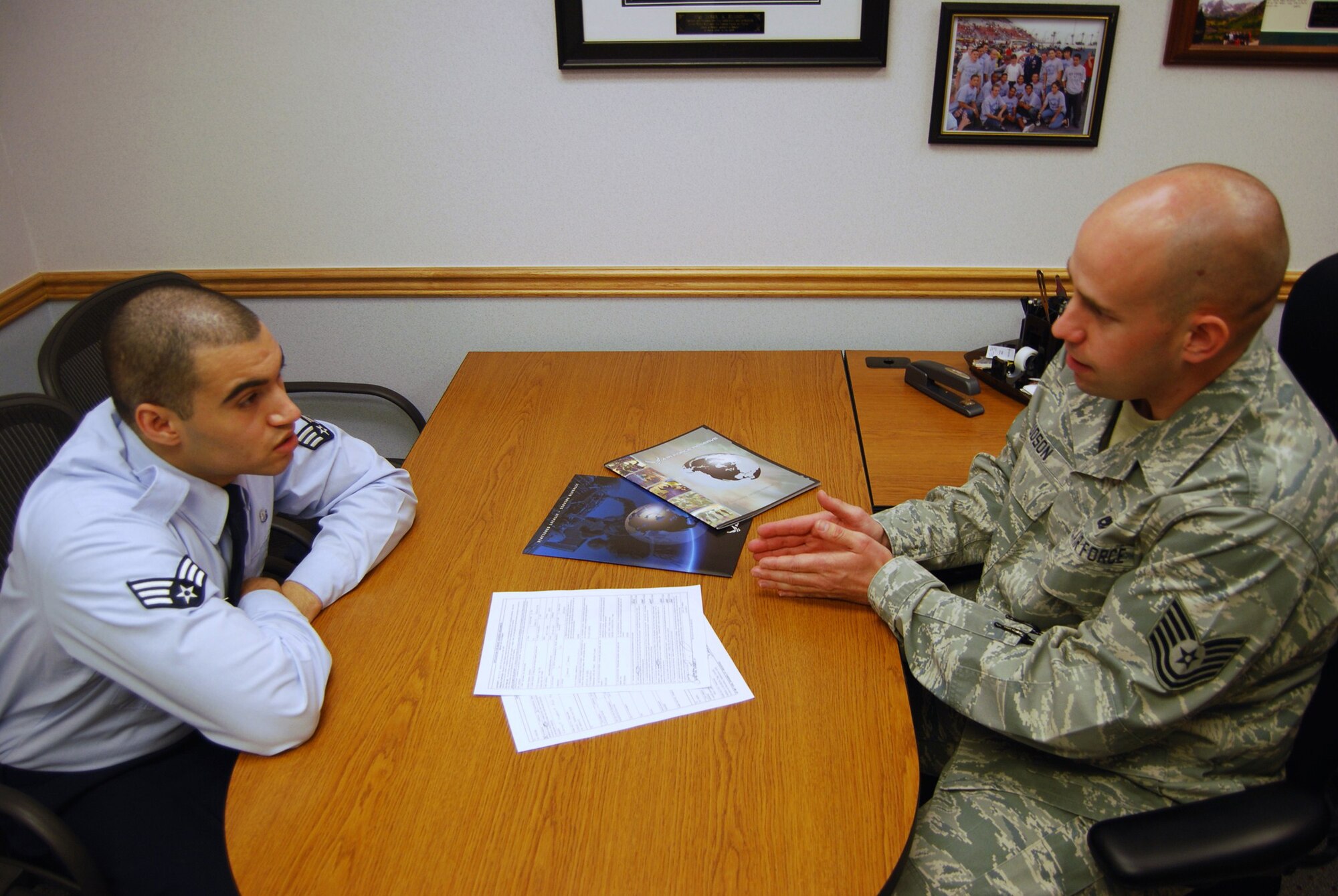Senior Airman Ramon Espinal, 341st Medical Group Public Heath technician, gets more information about the Palace Chase program from Tech. Sgt. Derek Hudson, 341st Force Support Squadron in-service recruiter. The palace chase program allows active-duty officers and Airmen to voluntarily transfer from active military service to the Reserve or Air National Guard. (U.S. Air Force photo/Airman 1st Class Kristina Overton)