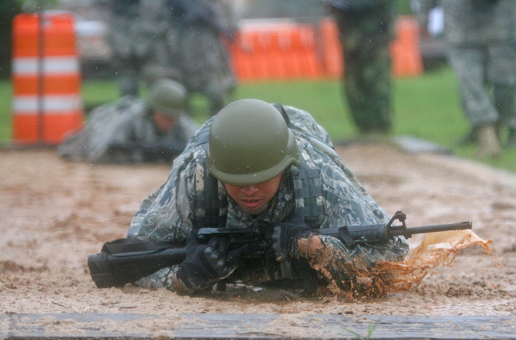 An Airman from the 201st Combat Communications Group at Hickam Air Force Base, Hawaii, sloshes through the combat course at Tinker’s Glenwood Training Area April 17 during Air Force Space Command’s Combat Challenge. (Air Force photo by John Stuart)