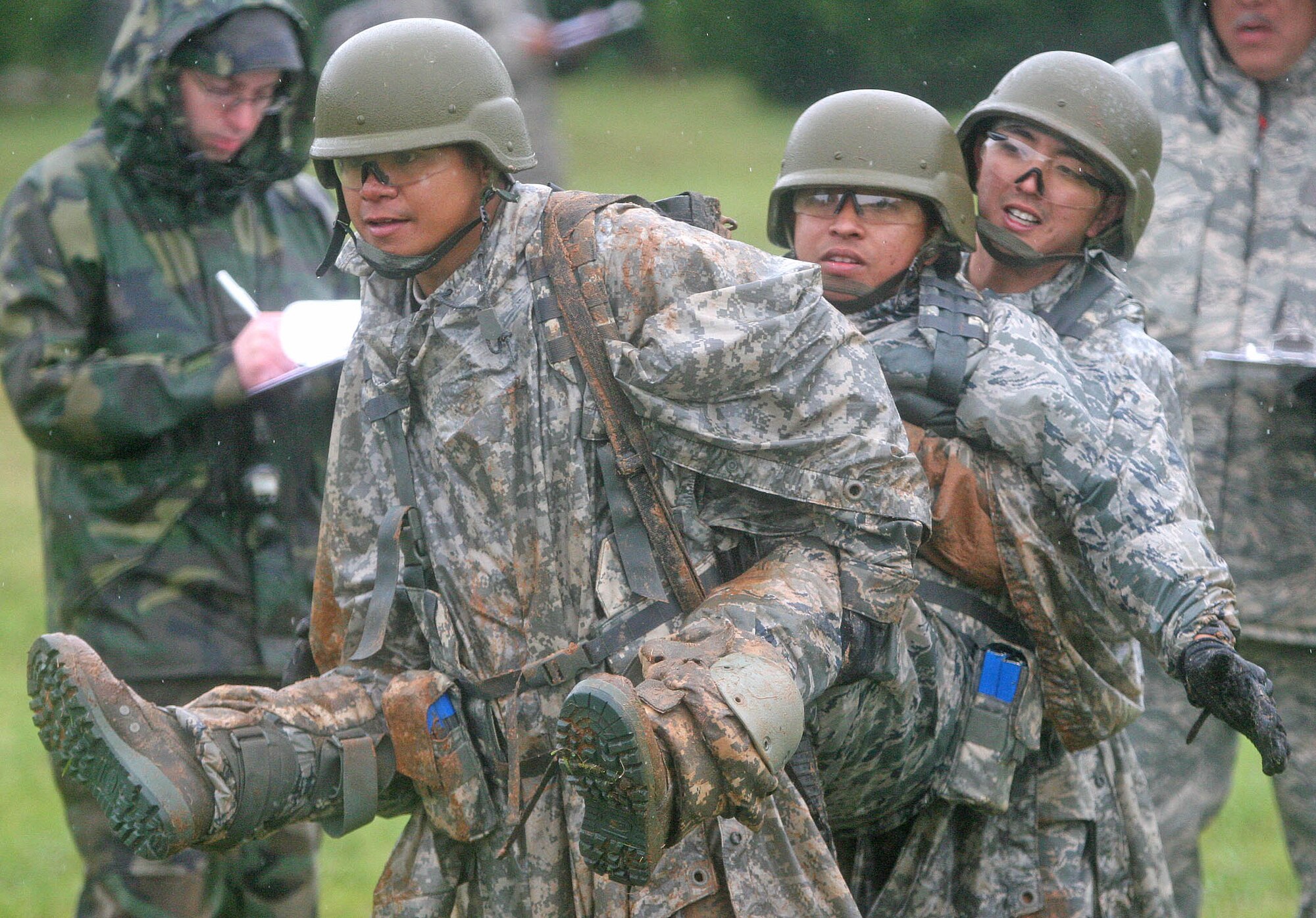 Staff Sgt. John Acidera, from left, Senior Airman Bricel Cabel and Staff Sgt. Jarvis Uehara from the 201st Combat Communications Group from the Hawaii Air National Guard coordinate movements for a mock, wounded buddy carry during the Team Tactical Challenge course April 17. The Hawaii unit had minimal time to train leading up to the competition but said the whole weekend was great mission-related experience. (Air Force photo by John Stuart)