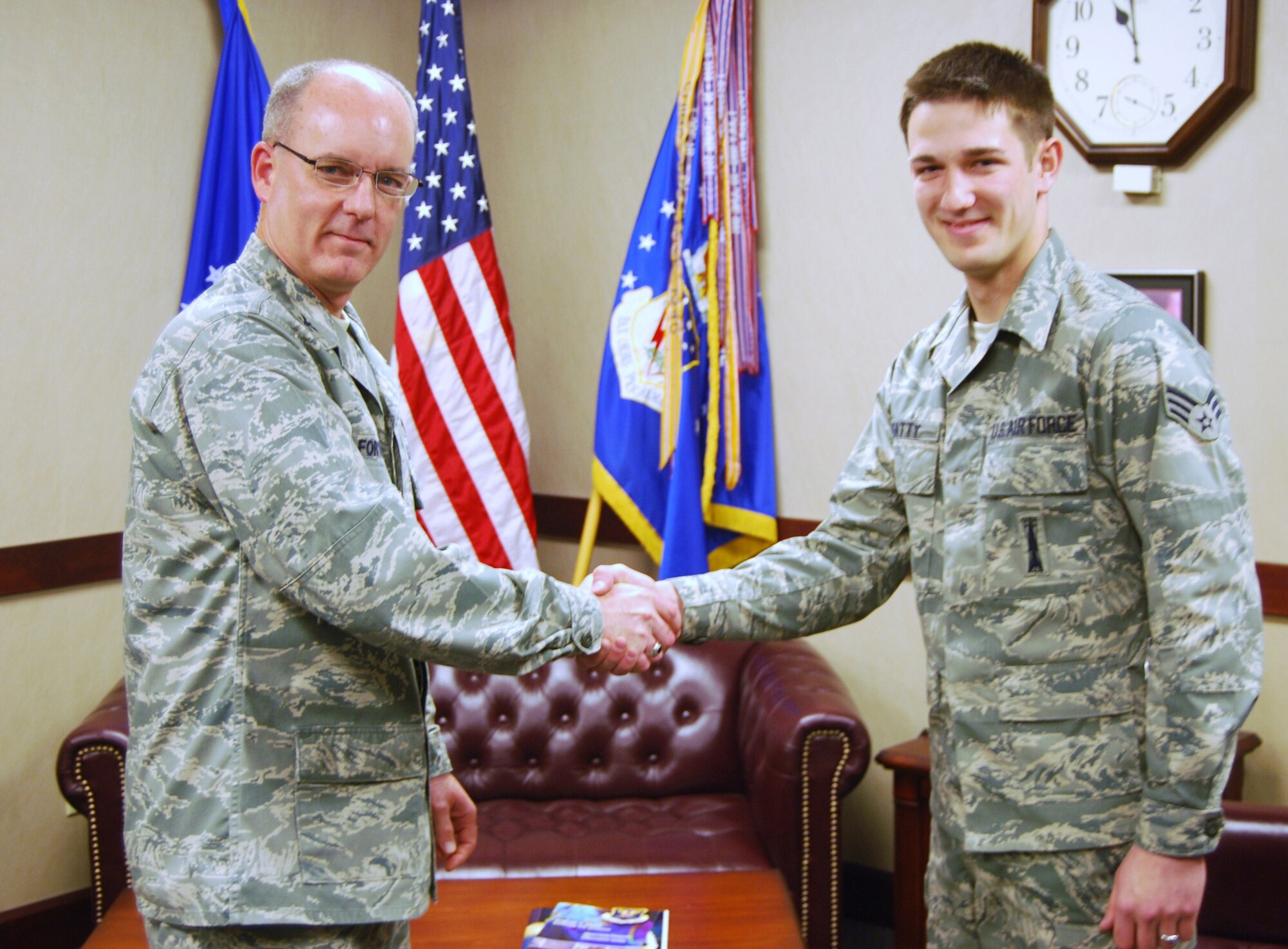 Senior Airman Joshua Beatty, 341st Missile Maintenance Squadron missile maintenance technician, was coined by Col. Michael Fortney, 341st Missile Wing commander, for completing his 100th safe payload transporter technical operation April 16. (U.S. Air Force photo/Airman 1st Class Kristina Overton)