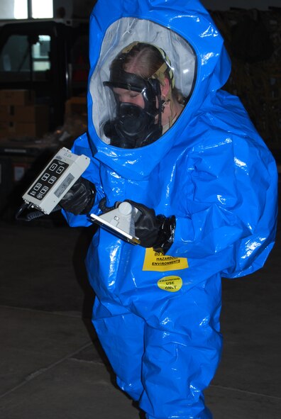 Airman 1st Class Brittany Musha, 341st Civil Engineer Squadron emergency management technician, scans over the results of an ADM 300, a radiation monitoring device during a simulated biohazard April 15. (U.S. Air Force photo/Airman 1st Class Kristina Overton)