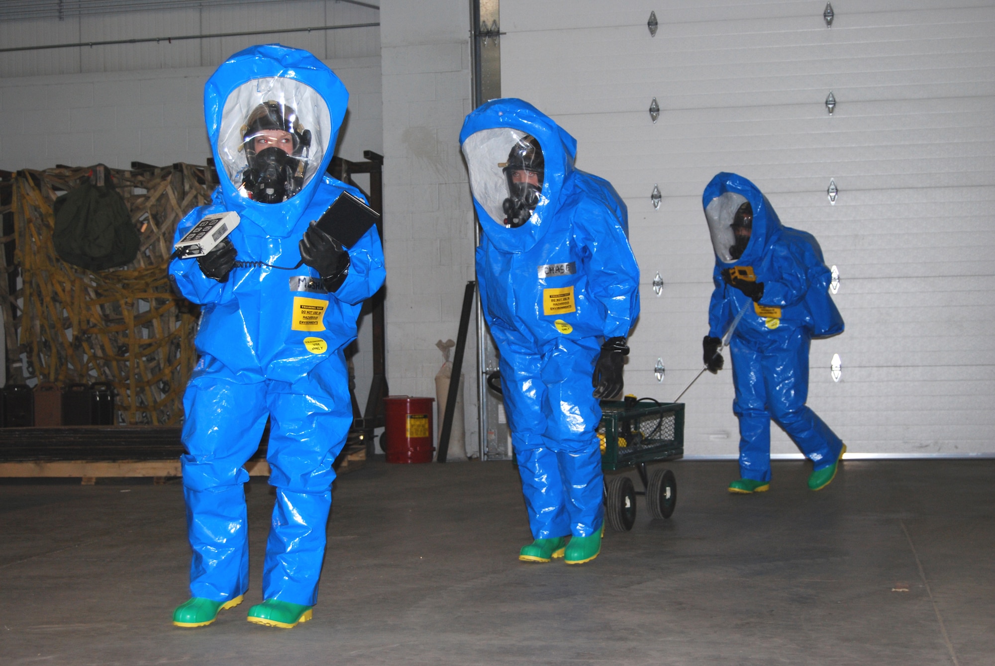 Airmen 1st Class Brittany Musha, Michelle Smith, and Senior Airman Rebecca Chase simulate preparing to enter biohazard area. (U.S. Air Force photo/Airman 1st Class Kristina Overton)