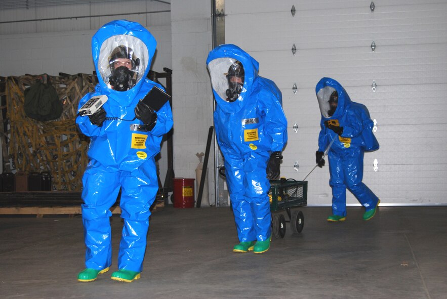 Airmen 1st Class Brittany Musha, Michelle Smith, and Senior Airman Rebecca Chase simulate preparing to enter biohazard area. (U.S. Air Force photo/Airman 1st Class Kristina Overton)