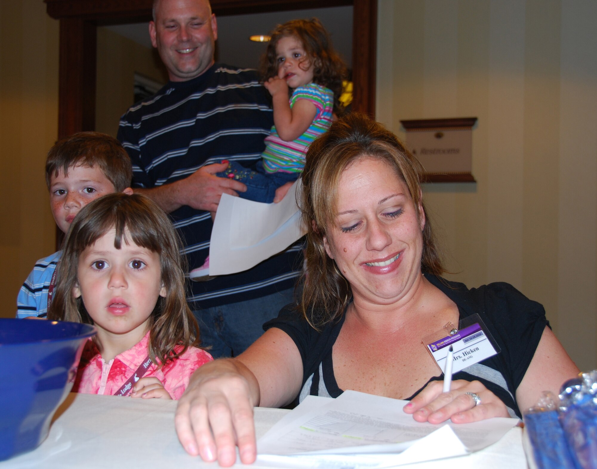 JOINT BASE MCGUIRE-DIX-LAKEHURST, N.J. - Air National Guardsman, Steve Hicken and his children wait while wife, Nicole, registers the family April 16 for the Yellow Ribbon Reintegration Event held at Hershey Lodge, Hersehy Pa. The event provides deployed Airmen resources to help ease their transition home post deployment. (U.S. Air Force photo/Master Sgt. Donna T. Jeffries)