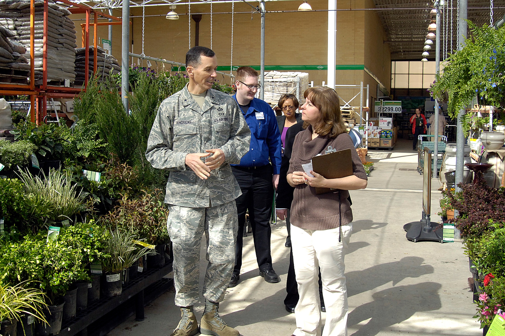 Brig. Gen. Fran Hendricks, Army and Air Force Exchange Service vice commander, was full of smiles and praise as he toured every inch of Tinker’s Base Exchange during his April 8 stop here. He surprised several employees with a coin for their excellent work and thanked shoppers with discount cards while describing the sweeping improvements scheduled for the store. Walking in the garden center with the general are, from right, Dawn Gumaer, area department manager; Bettye Golson, BX general manager; and Gregory Templeton, sales and merchandice manager. (Air Force photo by Margo Wright)