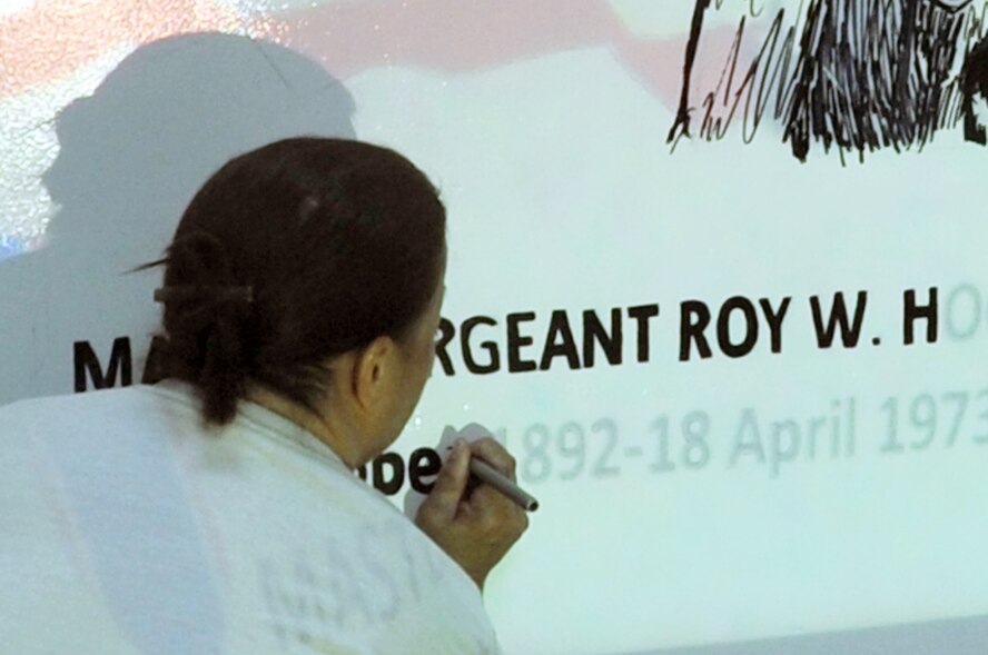 Tech. Sgt. Johnette Chun, NCO in charge of the night shift for Roy's Flight Kitchen in the operations area for the 380th Air Expeditionary Wing at a non-disclosed base in Southwest Asia, works on a mural April 18, 2010, honoring Master Sgt. Roy Hooe for whom the flight kitchen is named after. Sergeant Hooe is best known for his support of the first air refueling mission with the "Question Mark." Sergeant Chun is deployed from the Hawaii Air National Guard?s 154th Force Support Squadron at Hickam Air Force Base, Hawaii, and her hometown is Lihue, Kauai, Hawaii. (U.S. Air Force Photo/Master Sgt. Scott T. Sturkol/Released)