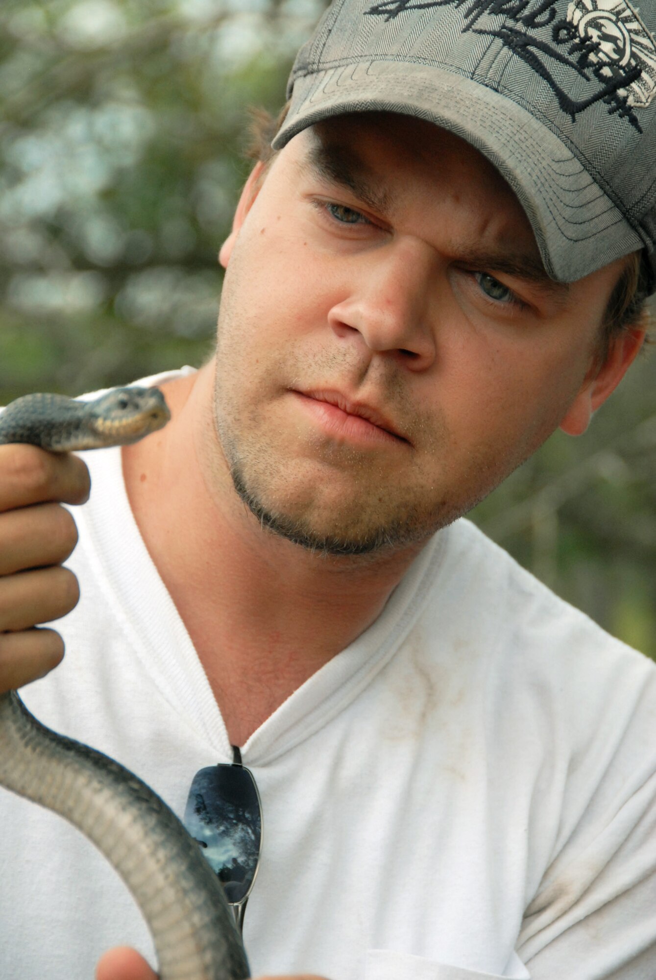 Taylor Tidwell, 96th Civil Engineer Group, holds an Eastern Hognose snake April 19 after the first-ever Kayak tour through the Eglin Air Force Base range.  The Hognose is a rare breed of non-poisonous snake found on the Eglin range. The five and a half mile kayak tour took 10 people down Boiling Creek and the Yellow River deep within the Eglin range.  The scenic tour showed off Eglin’s unique wild and plant life.  It kicked off Eglin’s week-long Earth Day celebration.   (U.S. Air Force photo/Samuel King Jr.)