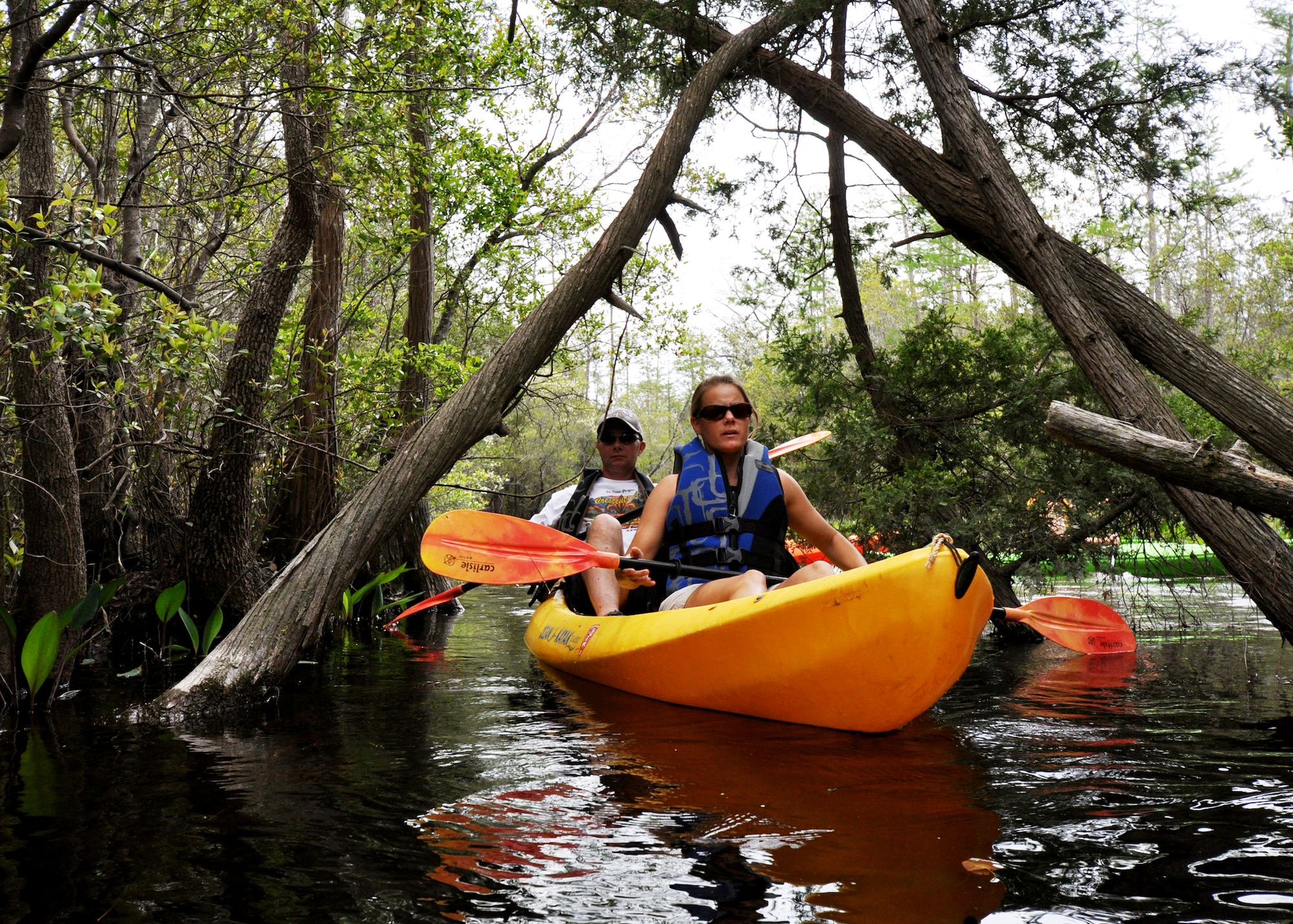 Erica and Steve Laine, 96th Civil Engineer Group, exit one of the many veins of Boiling Creek April 19 during the first-ever Kayak tour through the Eglin Air Force Base range. The five and a half mile kayak tour took 10 people down Boiling Creek and the Yellow River deep within the Eglin range.  The scenic tour showed off Eglin’s unique wild and plant life.  It kicked off Eglin’s week-long Earth Day celebration.   (U.S. Air Force photo/Samuel King Jr.)