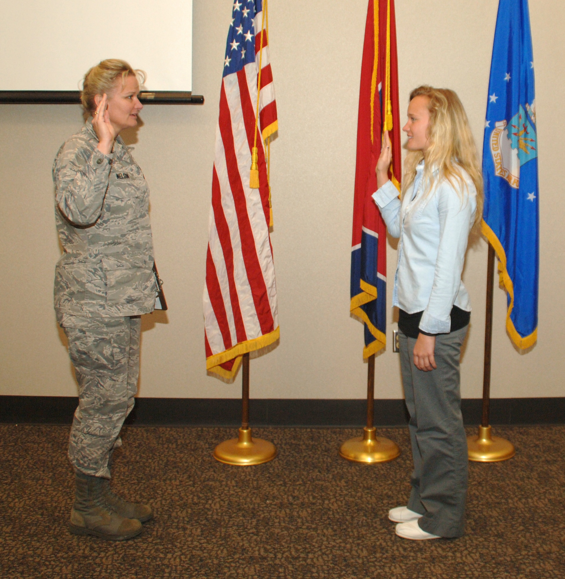 Maj. Lawana Nelson, Director of Personnel at the 118th Airlift Wing, administers the Oath of Office to her daughter, Lauren Lavery, April 20, formally swearing her into the Tennessee Air National Guard.