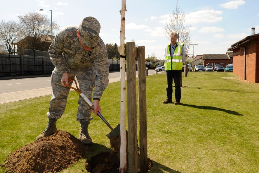 RAF MILDENHALL, England – Col. Jeffery Bateman, 100th Mission Support Group commander, helps plant a tree for Earth Week at the Child Development Center April 22.  Earth Week brings with it a myriad of projects to help the environment.  (U.S. Air Force photo/Staff Sgt. Christopher L. Ingersoll)