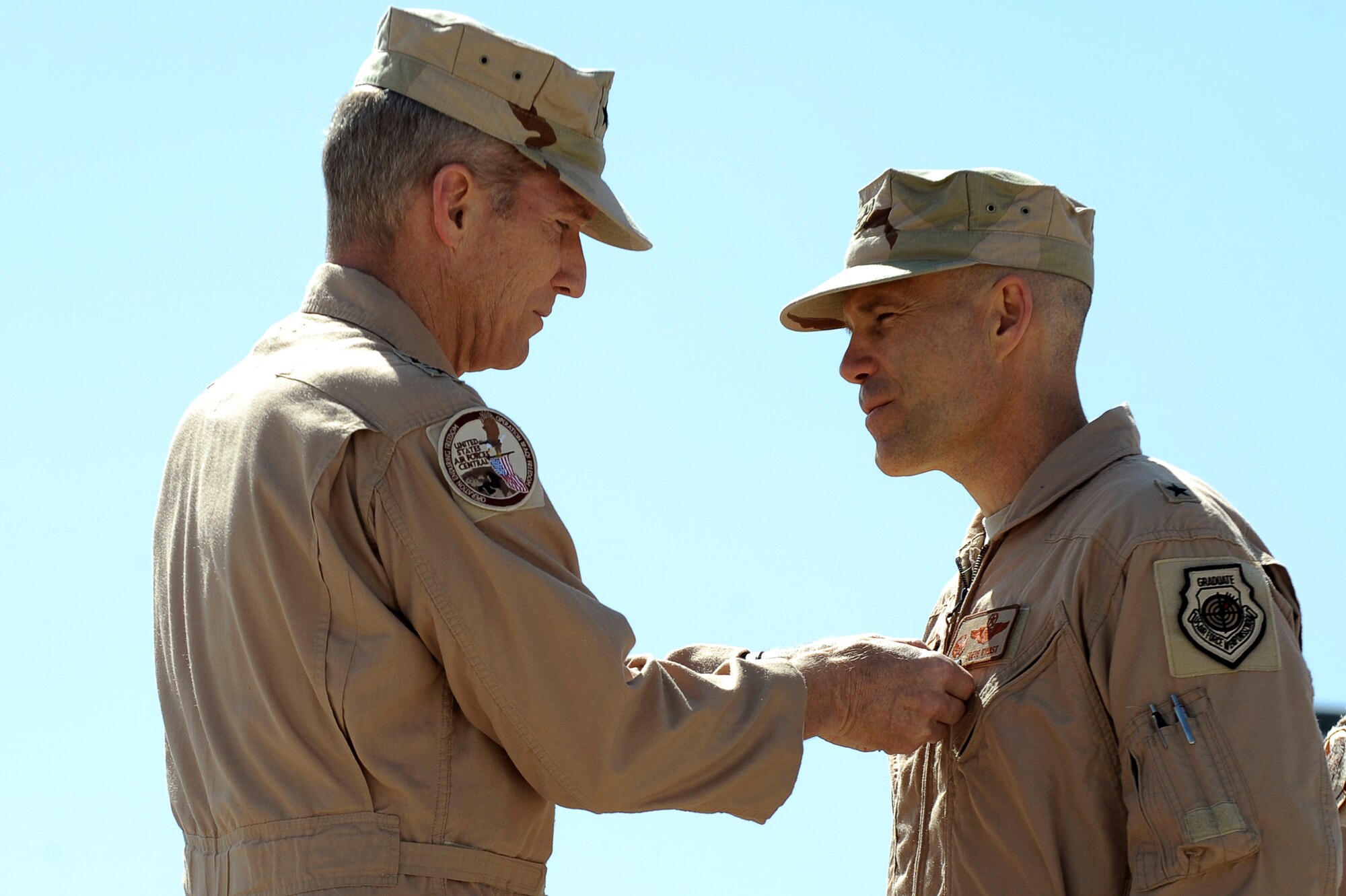 U.S. Air Force Lt. Gen. Mike Hostage III, U.S. Air Forces Central Command commander, presents the Bronze Star to Brig. Gen. Steven Kwast during the 455th Air Expeditionary Wing change of command ceremony at Bagram Airfield, Afghanistan, April 23, 2010. During the ceremony Brig. Gen. Steven Kwast transferred command to Col. Jack Briggs II. (U.S. Air Force photo by/ Tech. Sgt. Jeromy K. Cross/released)