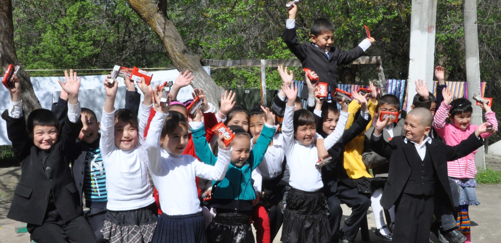 Children from the Sokulukskaya Special Boarding School/orphanage for children are excited to receive candy from military service members from the Transit Center at Manas, Kyrgyzstan, April 23, 2010. Airmen donated flour, oil, rice, and pasta for the 270 children there, who have had or need cleft palette surgery. (U.S. Air Force photo/Staff Sgt. Carolyn Viss)