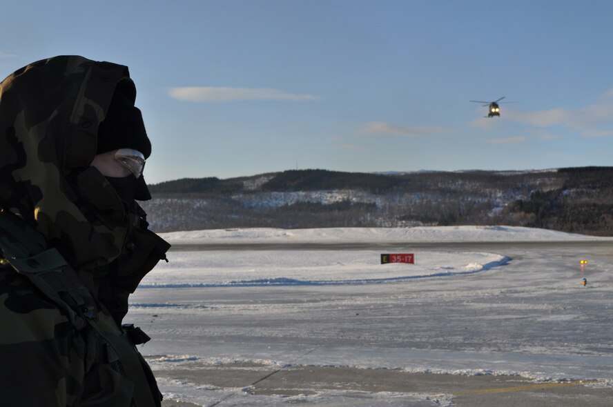 EVENES, Norway – Senior Airman Tara Skobel, 352nd Special Operations Group forward area refueling point team member, awaits the landing of a German NH-90 during Exercise Cold Response 10, an annual multinational training exercise.  The team conducted several practice FARP missions during daylight, but actual FARP missions are done in total darkness.   Airman Skobel was one of more than 200 352nd SOG members deployed to CR10.   (U.S. Air Force photo by Tech. Sgt. Marelise Wood) (U.S. Air Force photo/Tech. Sgt. Marelise Wood)