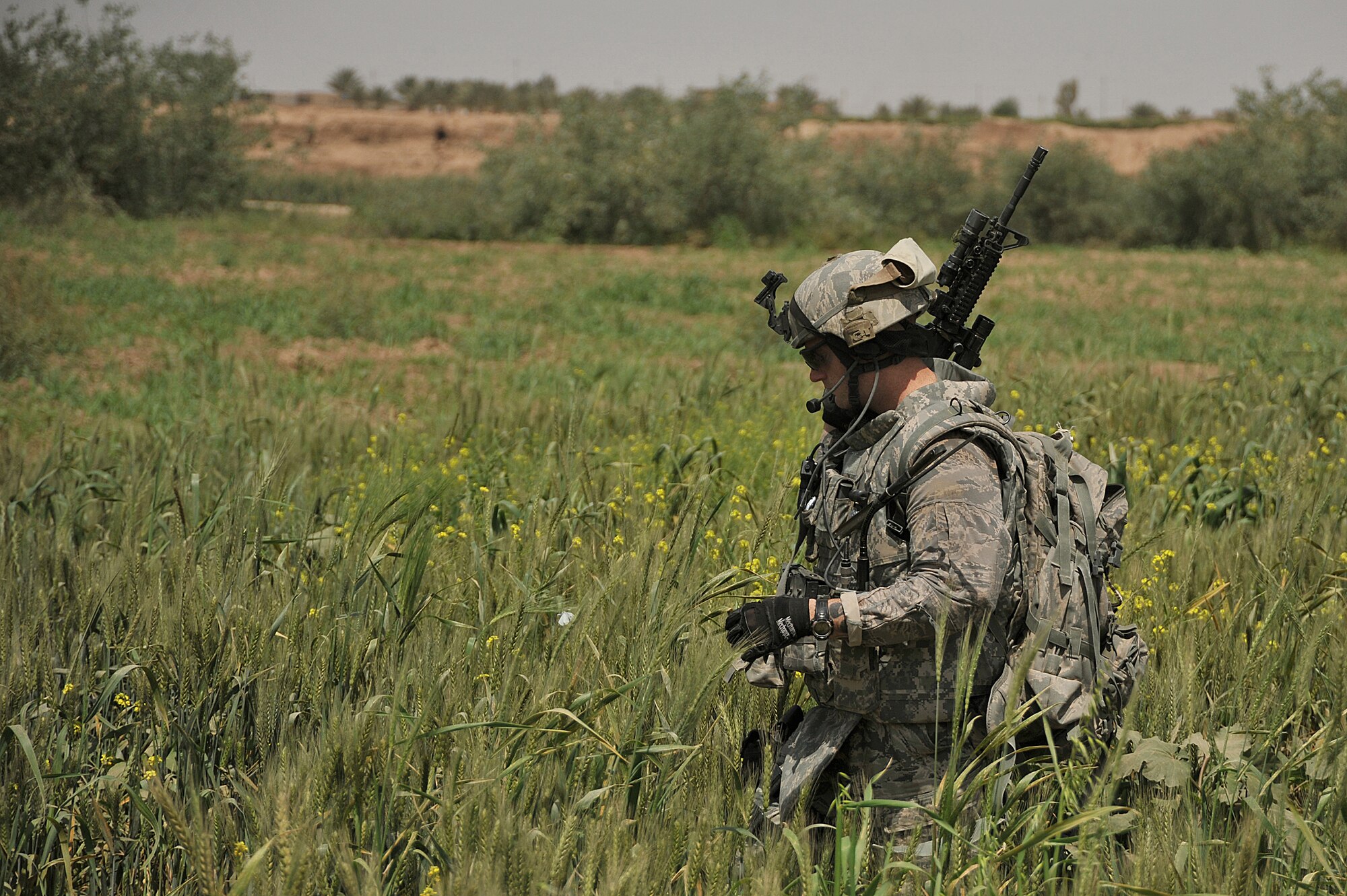 U.S. Air Force Staff Sgt. Benjamin Wilson patrols a field on the outskirts of Joint Base Balad on April 14, 2010.  The patrol was a joint effort between U.S. Army and Air Force defenders looking for weapons cache.  Sgt. Wilson is forward deployed to the 532nd Expeditionary Security Forces Squadron from Vandenberg AFB, Calif.(U.S. Air Force photo/Staff Sgt Quinton Russ/released)