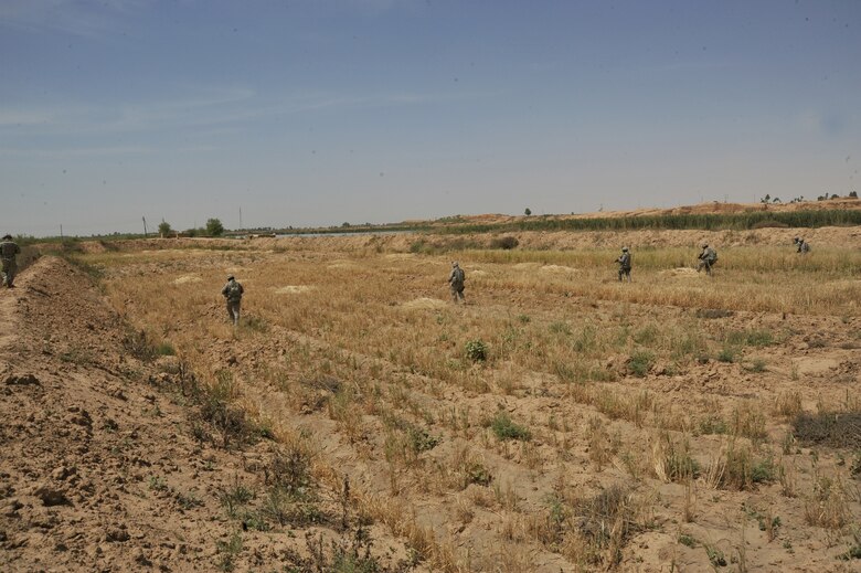 U.S. Air Force security forces sweep a field on the outskirts of Joint Base Balad April 14, 2010.  The patrol was a joint effort between U.S. Army and Air Force members looking for weapons caches.(U.S. Air Force photo/Staff Sgt Quinton Russ/released)